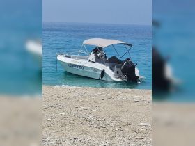 A sleek speedboat named 'Leonardo' anchored near a sandy beach, showcasing the perfect getaway for water enthusiasts.