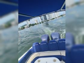 Interior view of the seating area on a boat named 'Sugar Daddy', showcasing comfortable seating and a clear view of the water ahead.