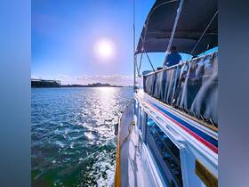 A stunning view of a yacht underway, capturing the shimmering water and bright sun, perfect for showcasing the beauty of a day on the water.