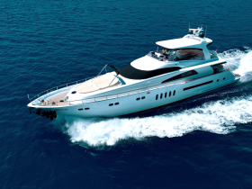 A stunning aerial view of a luxurious yacht cruising through deep blue waters, showcasing its sleek design and elegance — perfect for upscale charters and private getaways.