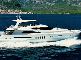 A stunning aerial view of a luxurious yacht cruising through clear blue waters, perfect for upscale charters and scenic adventures.