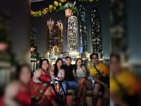 A cheerful group enjoys a night out on the water, surrounded by stunning city lights — perfect for memorable celebrations and gatherings.