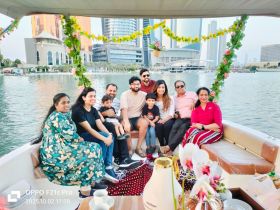 A joyful family gathers on a boat, enjoying a scenic view of the city skyline — perfect for memorable celebrations and family outings on the water.