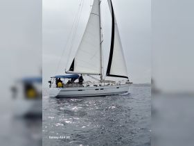 A sleek sailboat navigates the open waters, showcasing its elegant design and sails in action — perfect for sailing enthusiasts and adventure seekers.