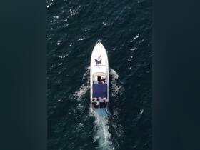 An aerial view of a boat cruising through the water, showcasing guests enjoying their time on board — perfect for highlighting fun on the water.
