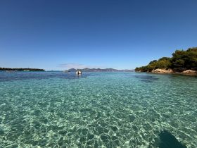 A stunning view of crystal-clear waters and a picturesque coastline, perfect for exploring the beauty of nature and enjoying a day on the water.