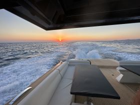 A stunning view of a boat cruising into the sunset, showcasing the serene waters and the beautiful horizon — perfect for evening excursions.