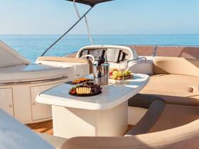 An elegant spread of cheese, fruits, and cocktails is beautifully arranged on a boat table, perfect for a luxurious day on the water.