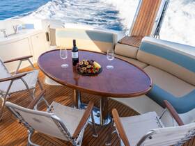 A beautifully arranged table featuring wine and a selection of fruits on a yacht's deck, perfect for enjoying refreshments while cruising on the water.