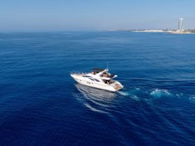 A stunning aerial view of a luxurious yacht cruising through deep blue waters, perfect for showcasing the elegance of boating adventures.