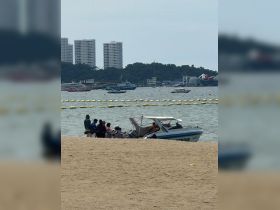 A group of people gathers around a boat on the beach, ready for a fun day of water activities. The vibrant setting captures the essence of family outings and beach adventures.