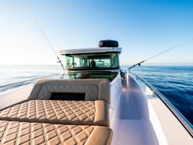 A sleek speedboat captured from the front, showcasing its stylish design and fishing gear, perfect for a day on the water.