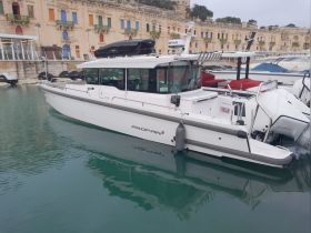 A sleek boat docked in a picturesque harbor, showcasing its modern design and surroundings — perfect for day trips and coastal adventures.