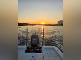 A serene view of a boat cruising at sunset, showcasing the tranquil waters and vibrant colors of the evening sky.