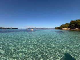 A stunning view of crystal-clear waters and a picturesque coastline, perfect for exploring the beauty of the islands.