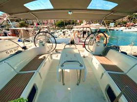 The interior of a sleek sailboat featuring a well-designed helm and comfortable seating, perfect for navigating the open waters.