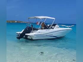 A sleek Cap Camarat speedboat anchored in crystal-clear turquoise waters, perfect for exploring beautiful coastal destinations.