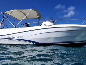 A sleek Cap Camarat boat glides through clear waters, showcasing its elegant design and perfect for a day of adventure on the sea.