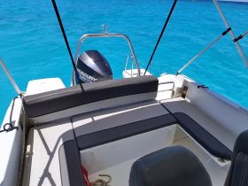A clean and spacious interior view of a boat's seating and helm area, perfect for enjoying a day on the water.