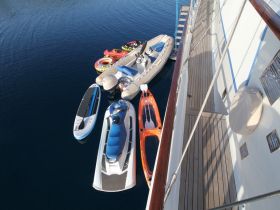 A collection of water sports equipment including jet skis, paddleboards, and inflatables, ready for fun on the water. Perfect for enhancing any boating adventure.