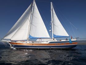 A stunning sailboat glides through the water, showcasing its elegant design and sails — perfect for a day of adventure on the open sea.