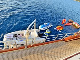 A variety of water toys, including jet skis and inflatables, are ready for fun on the water, showcasing the ultimate amenities for a boating adventure.