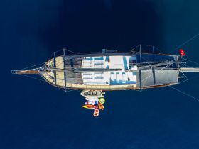 A stunning aerial view of a yacht showcasing its elegant design and spacious deck, perfect for luxury sailing experiences.