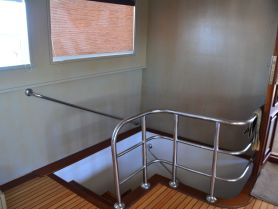 A view of the interior stairs leading down to the cabin area of a boat, showcasing the elegant design and functionality of the space.