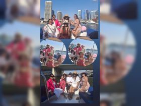 A lively group of friends enjoys a boat trip with a stunning cityscape backdrop, perfect for celebrations and memorable outings on the water.