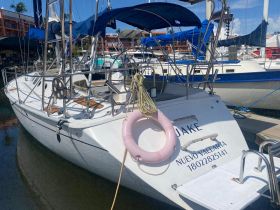 A pristine yacht named 'JAKE' docked in Nuevo Vallarta, showcasing its sleek design and inviting atmosphere for future adventures on the water.