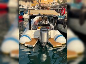 A sleek motorboat docked in a marina, showcasing its streamlined design and inviting seating area, perfect for leisurely outings on the water.