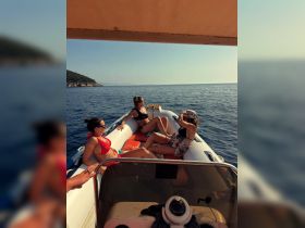 A group of friends relaxes on a boat, enjoying the sun and sea — the perfect summer getaway for fun and relaxation.