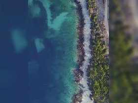 Aerial view of a coastal area with unclear details; the image lacks identifiable subjects or clarity.