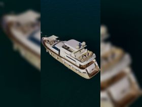 A stunning aerial view of a luxurious yacht, showcasing its elegant design and spacious deck, perfect for relaxing on the water.