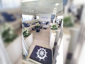 A beautifully designed interior of a boat featuring elegant seating and nautical decor, perfect for relaxing and entertaining guests on the water.
