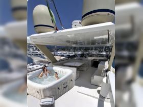 A relaxing scene featuring a jacuzzi on a boat's deck, with a woman and a child enjoying the water — perfect for luxurious boating experiences.