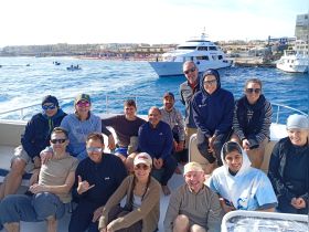 A lively group of friends enjoys a day out on the boat, capturing the essence of fun and camaraderie on the water.