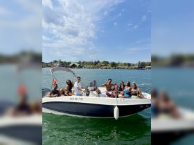 A lively group enjoys a fun day on the water aboard a boat, showcasing the perfect atmosphere for celebrations and gatherings.