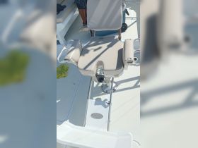 A close-up view of a comfortable helm seat on a boat, showcasing the sleek design and functionality for an enjoyable boating experience.