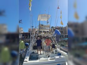 A group of friends prepares for a fishing trip aboard a well-equipped boat, showcasing camaraderie and excitement for the day's adventure.