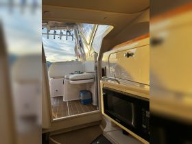 Interior view of a boat's cabin showcasing seating and amenities, perfect for relaxing during a day on the water.