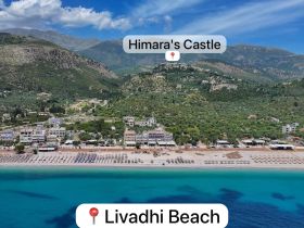 A stunning aerial view of Livadhi Beach with Himara's Castle in the background, showcasing the beautiful coastline and vibrant blue waters — a perfect destination for beach lovers.
