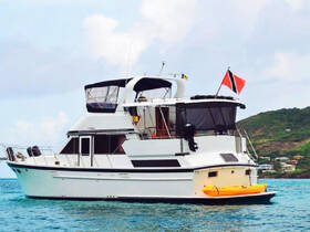 A beautiful yacht anchored in clear waters, showcasing its elegant design and vibrant colors, perfect for luxury charters and coastal adventures.
