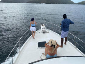 A group of friends enjoys the open sea on a boat, capturing the essence of adventure and relaxation on the water.