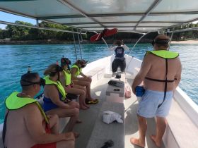 A group of snorkelers prepares for an underwater adventure on a boat, showcasing the excitement of marine exploration.