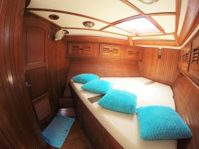 Cozy interior cabin of a boat featuring comfortable seating and wooden finishes, perfect for relaxation during your nautical adventures.