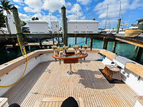 The interior of a fishing boat featuring a well-equipped helm and spacious seating area, perfect for a day on the water.