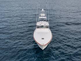 Aerial view of a sleek yacht cruising through open waters, showcasing its elegant design and structure — perfect for luxury boating experiences.