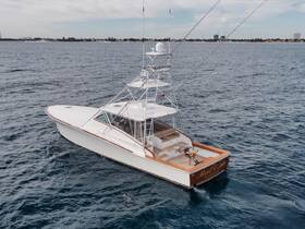 A stunning aerial view of a sleek yacht cruising through open waters, showcasing its elegant design and perfect for luxury charters.