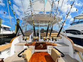 The interior of a well-equipped fishing boat featuring a spacious helm and fishing gear, perfect for avid anglers looking to enjoy a day on the water.